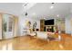 Cozy living room featuring a fireplace with a flatscreen TV, hardwood floors, and large windows for natural light at 999 N Emerson St # 9, Denver, CO 80218