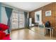Bright living area with brick accent wall, mirrored cabinet, light wood floors and French doors leading to the balcony at 999 N Emerson St # 9, Denver, CO 80218