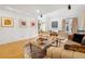 Spacious living room with hardwood floors, modern decor, and large windows offering bright, natural lighting at 999 N Emerson St # 9, Denver, CO 80218