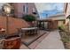 Outdoor patio with dining and sitting areas, greenery, and mature landscaping around the home at 999 N Emerson St # 9, Denver, CO 80218