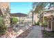 Private patio with comfortable seating, shaded by a large umbrella and flowering trees at 999 N Emerson St # 9, Denver, CO 80218