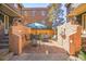 Charming patio with an umbrella table, seating, a stone fountain, and verdant foliage at 999 N Emerson St # 9, Denver, CO 80218