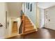 Bright stairway featuring hardwood stairs, decorative wainscoting, and modern lighting at 999 N Emerson St # 9, Denver, CO 80218