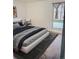 Serene bedroom featuring a plush bed with stylish bedding and a sunlit window at 6495 E Happy Canyon Rd # 79, Denver, CO 80237