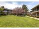 Beautifully landscaped condo complex with lush green lawns and mature shade trees at 6495 E Happy Canyon Rd # 79, Denver, CO 80237