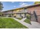 Charming condo complex with well-maintained lawn, mature trees, and individual balconies at 6495 E Happy Canyon Rd # 79, Denver, CO 80237