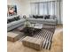 Inviting living room with comfortable sofas, patterned rug, and elegant decor for relaxation at 6495 E Happy Canyon Rd # 79, Denver, CO 80237