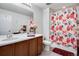 Full bathroom with a vanity, mirror, and a shower with a floral curtain at 16470 Mountain Flax Dr, Monument, CO 80132