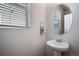 Half bathroom with a pedestal sink, mirror, and a window that brings in natural light at 16470 Mountain Flax Dr, Monument, CO 80132
