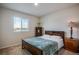 Bedroom with bed, bedside table and lamp, a large window and a decorative shelf at 16470 Mountain Flax Dr, Monument, CO 80132