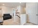 Well-lit hallway with a comfortable couch, a bookshelf, and carpet flooring at 16470 Mountain Flax Dr, Monument, CO 80132