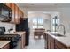 Well-lit kitchen with stainless steel appliances and a view of the dining area at 16470 Mountain Flax Dr, Monument, CO 80132