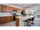 Modern kitchen with stainless steel appliances, quartz countertops, and breakfast bar seating at 16470 Mountain Flax Dr, Monument, CO 80132
