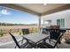 Covered patio area with outdoor dining set and grill, perfect for entertaining at 16470 Mountain Flax Dr, Monument, CO 80132