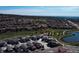 Expansive aerial shot showcases a thriving residential area with a pond and green spaces at 15576 W Washburn Cir, Lakewood, CO 80228