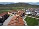 Wide aerial perspective of a neighborhood with well-kept homes, green lawns, and mountain views at 15576 W Washburn Cir, Lakewood, CO 80228