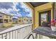 Balcony view showcasing the neighborhood's colorful townhomes against a cloudy sky at 15576 W Washburn Cir, Lakewood, CO 80228