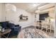 Finished basement area with cozy seating, a study desk, and modern decor at 15576 W Washburn Cir, Lakewood, CO 80228