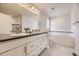 Elegant bathroom with double vanity, soaking tub, and tiled shower, offering a spa-like experience at 15576 W Washburn Cir, Lakewood, CO 80228