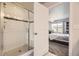 Ensuite bathroom with glass shower adjacent to a comfortable bedroom with ample natural light at 15576 W Washburn Cir, Lakewood, CO 80228