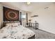 Comfortable bedroom with desk, soft textures, and window view at 15576 W Washburn Cir, Lakewood, CO 80228