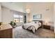 Serene bedroom with a cozy bed, side tables, and a view of the neighborhood through a window at 15576 W Washburn Cir, Lakewood, CO 80228