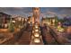 Grand community entrance with stone architecture, elegant landscaping, and water feature at 15576 W Washburn Cir, Lakewood, CO 80228