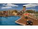 Resort-style community pool with ample seating, lounge chairs, and scenic mountain backdrop at 15576 W Washburn Cir, Lakewood, CO 80228