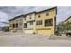 Stylish townhome showcases a modern exterior, with multiple units in complementary colors and garages at 15576 W Washburn Cir, Lakewood, CO 80228
