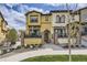Charming, two-story home boasting a manicured lawn, stone accents, and a cozy front patio perfect for enjoying the outdoors at 15576 W Washburn Cir, Lakewood, CO 80228