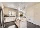 Well-lit kitchen with modern island, stainless appliances, and sleek countertops, creating a chef's dream space at 15576 W Washburn Cir, Lakewood, CO 80228