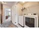 Convenient laundry room with modern washer and dryer, plus ample shelving for storage at 15576 W Washburn Cir, Lakewood, CO 80228