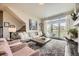 Bright and airy living room featuring a modern fireplace, plush seating, and a sliding door to a patio area at 15576 W Washburn Cir, Lakewood, CO 80228
