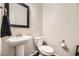 Cozy powder room with pedestal sink, modern fixtures, and clean, minimalist design at 15576 W Washburn Cir, Lakewood, CO 80228