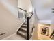 Carpeted staircase with stylish railings leads to upper level, enhancing the home's modern design at 15576 W Washburn Cir, Lakewood, CO 80228