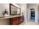 Bathroom with double vanity, granite countertop, and walk-in closet at 6945 N Fargo Trl, Littleton, CO 80125