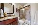 Bathroom featuring granite countertop vanity and tiled walk-in shower with glass doors at 6945 N Fargo Trl, Littleton, CO 80125