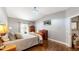 Comfortable bedroom featuring hardwood floors, vaulted ceiling, and ample natural light at 6945 N Fargo Trl, Littleton, CO 80125
