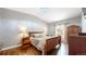 Cozy bedroom with hardwood floors, chandelier, and natural light from the window at 6945 N Fargo Trl, Littleton, CO 80125