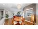 Formal dining room with modern chandelier, hardwood floors, and backyard views at 6945 N Fargo Trl, Littleton, CO 80125