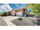 Charming home exterior featuring a two-car garage, stone accents, and landscaped front yard at 6945 N Fargo Trl, Littleton, CO 80125