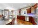 Gourmet kitchen with stainless steel appliances, gas cooktop island, and cherry wood cabinets at 6945 N Fargo Trl, Littleton, CO 80125