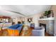 Living room with fireplace, blue leather couch, hardwood floors, and kitchen access at 6945 N Fargo Trl, Littleton, CO 80125