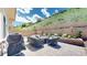 Relax and unwind on this private outdoor patio with plush seating, a gas grill and hillside views at 6945 N Fargo Trl, Littleton, CO 80125
