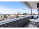 This balcony features a metal railing, string lights and chairs with a table at 1245 Utica St # 105, Denver, CO 80204
