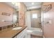 A well-lit bathroom with a granite countertop, modern fixtures, and tiled walls at 1245 Utica St # 105, Denver, CO 80204