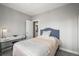 This bedroom features a bed, desk and chair with a large open door at 1245 Utica St # 105, Denver, CO 80204