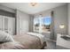 This bedroom features a bed, large windows and a dresser with mirror at 1245 Utica St # 105, Denver, CO 80204