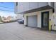 Attached garage with a gray door, complemented by a blue door entrance, offering convenient parking at 1245 Utica St # 105, Denver, CO 80204