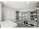 Upstairs hallway with metal railings, a light-filled open space, and modern design elements at 1245 Utica St # 105, Denver, CO 80204